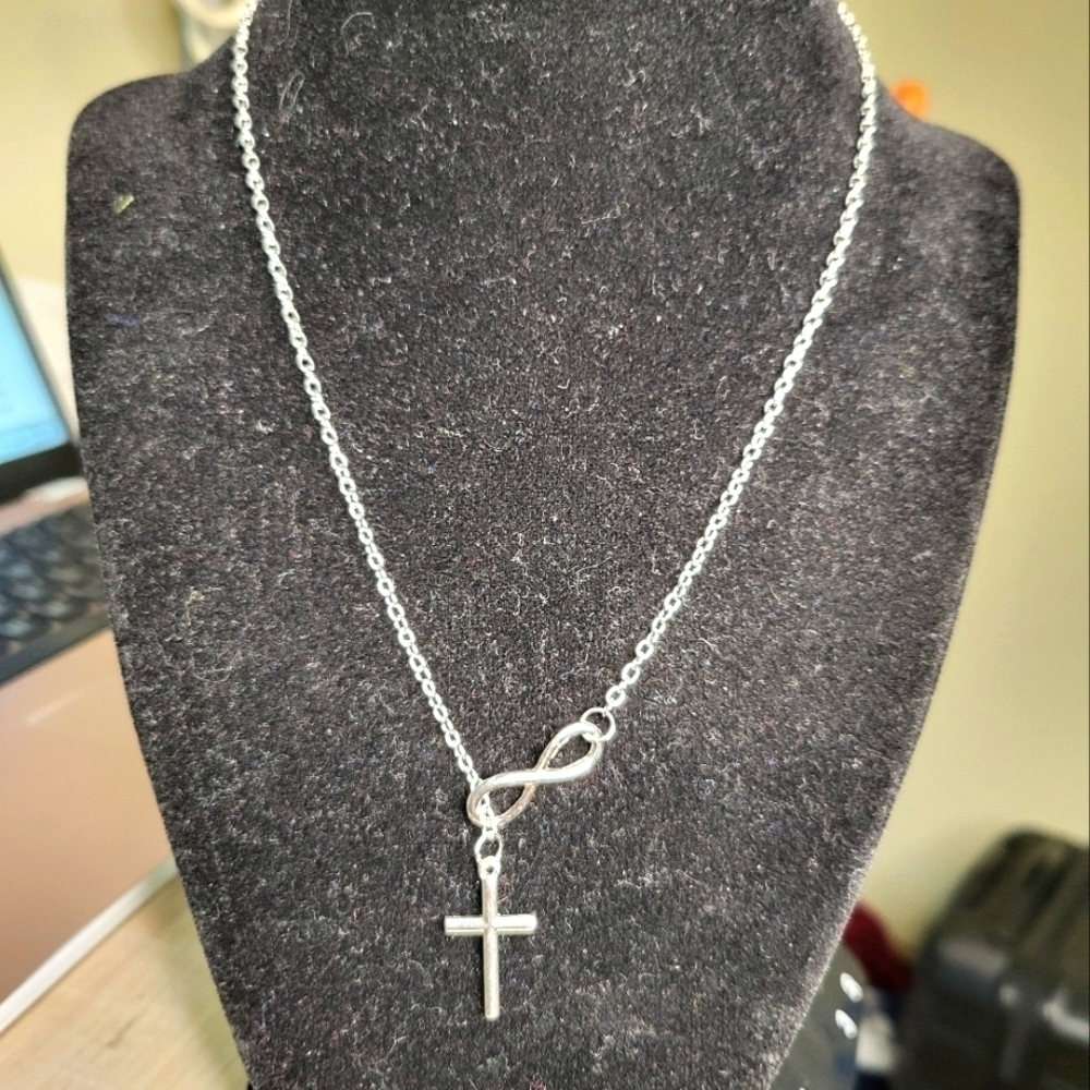 NWOT Infinity Necklace Silver, cross runs inside infinity to endless design